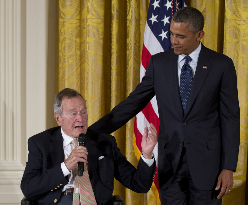 Former President George H. W. Bush speaks as President Barack Obama stands at right during a ceremony to present the 5,000th Daily Point of Light Award to Floyd Hammer and Kathy Hamilton of Union, Iowa, at the White House on Monday.