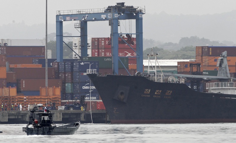 Police patrol by boat next to the North Korean-flagged cargo ship Chong Chon Gang docked at the Manzanillo International container terminal on the coast of Colon City, Panama, Tuesday, July 16, 2013. Panama's president said the country has seized the ship, carrying what appeared to be ballistic missiles and other arms that had set sail from Cuba. (AP Photo/Arnulfo Franco)