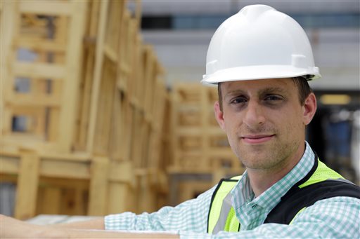 Drew Miller, shown here at a building under construction on Wednesday in Silver Spring, Md., quit a steady government job to take a chance on a company that's using "smart technologies" to help big corporations cut lighting costs.