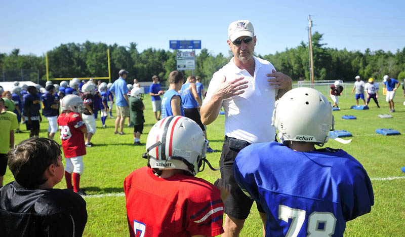 WORDS FROM A PRO: Former New England Patriots’ quarterback Steve Grogan talks to campers during the Central Maine Football Camp on Saturday at Bill Donahue Field in the Richard McGee Athletic Complex in Fairfield.