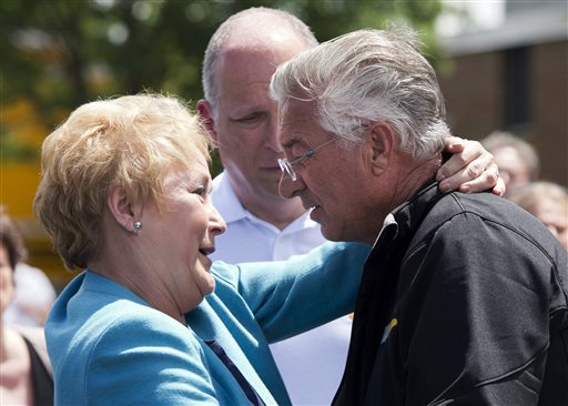 Raymond Lafontaine, who lost his son and two daughters-in-law, receives a hug from Quebec Premier Pauline Marois during her visit to Lac-Megantic, Quebec on Thursday, as Marois toured the site where a runaway oil train killed 50 people in a fiery explosion.