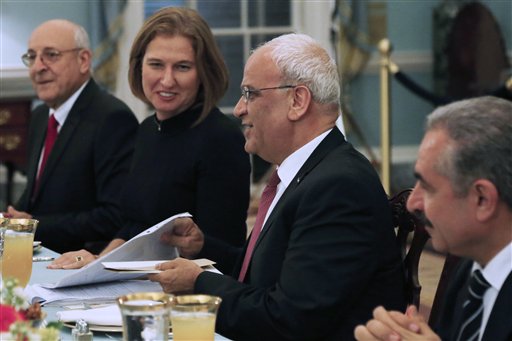 Israel's Justice Minister and chief negotiator Tzipi Livni, second left, Palestinian chief negotiator Saeb Erekat, second right, Yitzhak Molcho, an adviser to Israeli Prime Minister Benjamin Netanyahu, left, and Mohammed Shtayyeh, aide to Palestinian President Mahmoud Abbas, right, are seated across from Secretary of State John Kerry, not pictured, at an Iftar dinner, which celebrates Ramadan, at the State Department in Washington, marking the resumption of Israeli-Palestinian peace talks on Monday.
