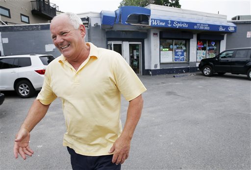 In this June 6, 2013, photo, Stephen Rakes greets an acquaintance outside the liquor store he once owned in the South Boston neighborhood of Boston. Authorities say Rakes, who was on the witness list for the racketeering trial of reputed mobster James "Whitey" Bulger, has died.