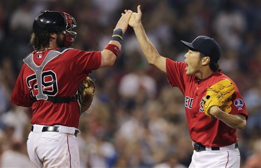 Boston Red Sox relief pitcher Koji Uehara, right, leaps high fives catcher Jarrod Saltalamacchia after getting New York Yankees' Eduardo Nunez to ground out to end the game during the ninth inning of a baseball game at Fenway Park, Friday, July 19, 2013, in Boston. (AP Photo/Charles Krupa)