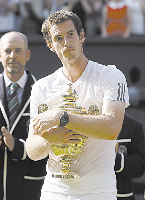 CLOSE TO THE HEART: Andy Murray holds the trophy after defeating Novak Djokovic for the Wimbledon title Sunday in Wimbledon, London.