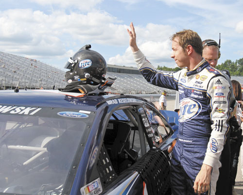 THANK YOU, THANK YOU: Brad Keselowski waves to fans Friday after winning the pole during qualifying for Sunday’s NASCAR Sprint Cup race in Loudon, N.H.