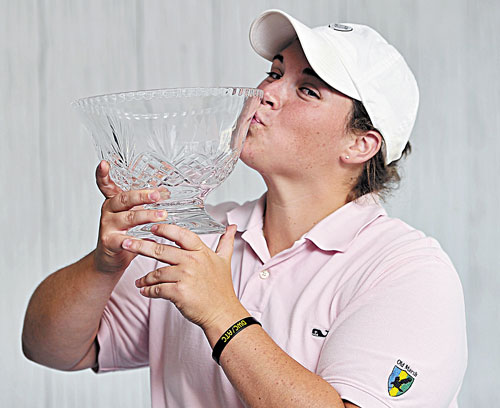 WINNER: Emily Bouchard gives a playful kiss to the trophy after she wins the Maine Women’s Amateur on Wednesday at the Brunswick Golf Club.