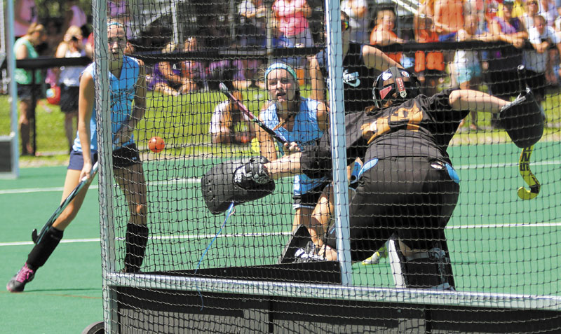 A SHOOTING ALL-STAR: Recent Skowhegan Area High School graduate Sarah Finnemore, playing for the East squad, puts a shot just wide of the West's goalie Patty Smith of Gorham High School during the annual McNally Senior All-Star Field Hockey game on Saturday at Colby College in Waterville. Finnemore plans to attend Harvard University this fall.