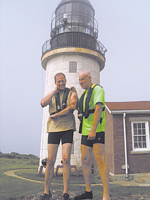 Dan Benson, left, and David Grody share a sense of relief on June 30 shortly after crashing their boat on Seguin Island three miles from Popham Beach.