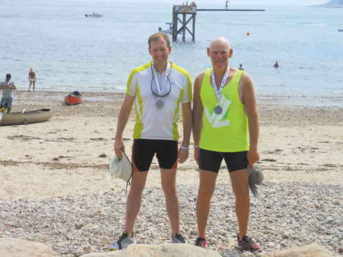 PROUD: Dan Benson, left, and David Grody are shown with their second-place medals after participating in the Blackburn Challenge, a 20-mile race around Cape Ann in Gloucester, Mass.