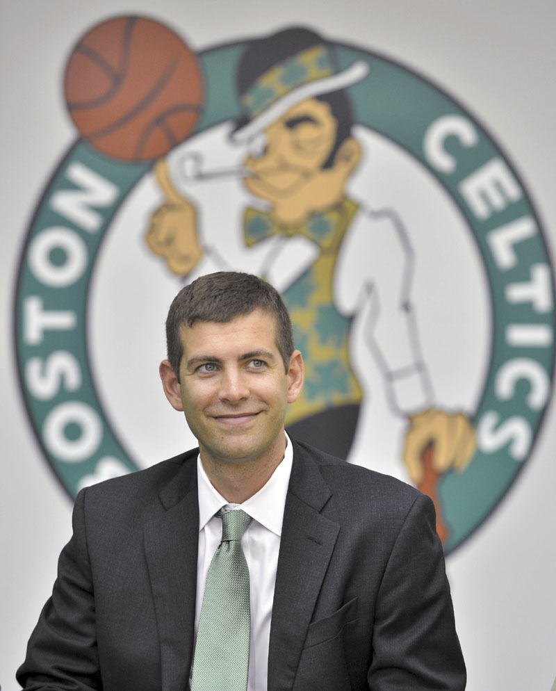New Boston Celtics head coach Brad Stevens reacts to a question during a news conference where he was introduced Friday, July 5, 2013, at the NBA basketball team's training facility in Waltham, Mass. Stevens twice led the Butler Bulldogs to the NCAA title game. He replaces Doc Rivers, who was traded to the Los Angeles Clippers. (AP Photo/Josh Reynolds)