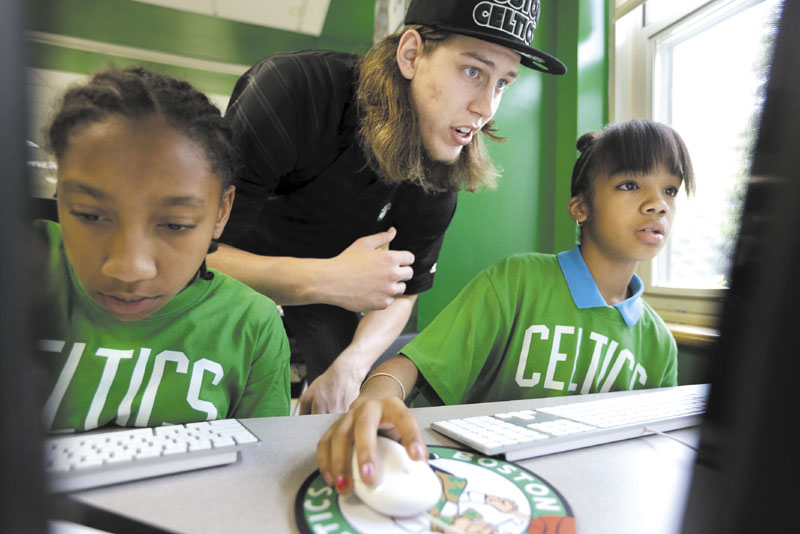 LET ME TAKE A LOOK: First-round draft pick Kelly Olynyk, center, assists Jillian Ayler, 11, left, and Kanashia Howard, 12, both of Boston, in a technology lab at the Mildred Ave Teen Center on Monday in Boston. The Celtics introducted Olynyk and second-round pick Colton Iverson on Monday.