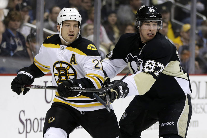 FERENCE ON THE MOVE: Pittsburgh Penguins center Sidney Crosby (87) checks Boston Bruins defenseman Andrew Ference during a game this season. The Edmonton Oilers signed Ference, a former Bruins defenseman, to a four-year deal reportedly worth $13 million.