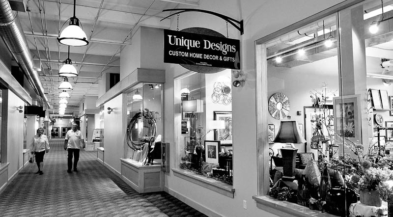 Customers at the Hathaway Creative Center in Waterville walk down the long corridor toward the Unique Designs store after dropping by Maynard's Chocolates.