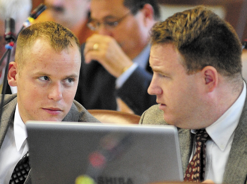 Rep. Corey Wilson, R-Augusta, left, chats with Rep. Jarrod Crockett, R-Betherl, during a House session on June 18 in the State House in Augusta.