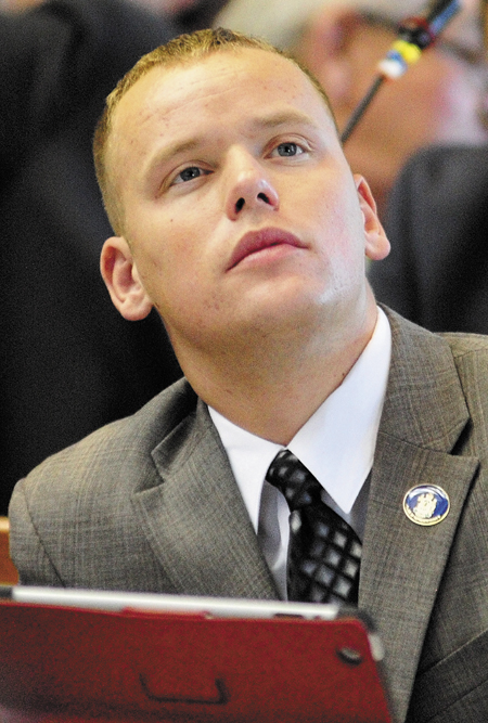 Rep. Corey Wilson, R-Augusta, looks up at the tally board during a vote in a House session on Tuesday in the State House in Augusta.