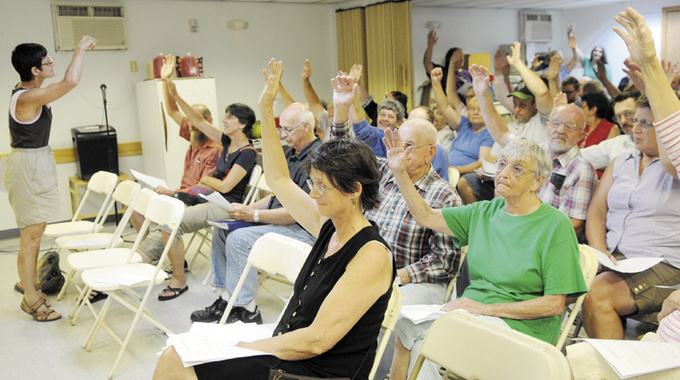 Hands of Pittston residents are counted Thursday during a special town meeting to fund town operations.