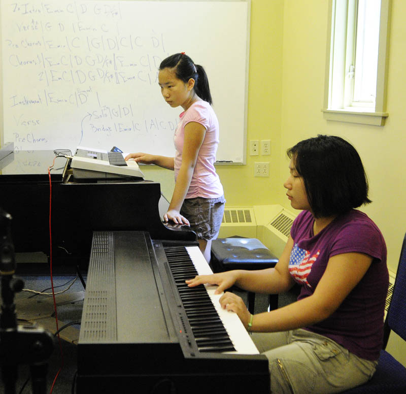Hannah Qui, 13, left, and Erin Qui, 14, both of Gardiner, play their keyboards during Rock Camp on Wednesday at the University of Maine at Augusta.