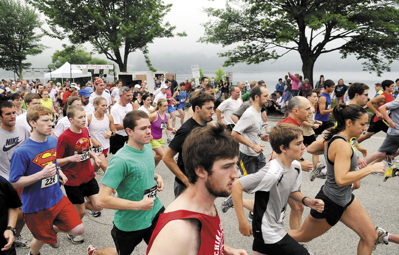 BIG RACE: Runners take off from the start line during a recent edition of the Friends on the 4th 5K in Winthrop. The race, which benefits the Cobbossee Watershed and is in its 11th year, has grown from 97 runners to 686 last summer.