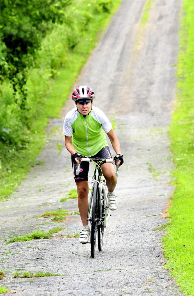 Chris Nichols, of Winslow, peddles up a hill while preparing for a ride this Saturday to show support for a Canaan woman who was recently assaulted. The ride begins at 10 a.m. at Fedco Seeds on the Hinckley Road in Clinton.