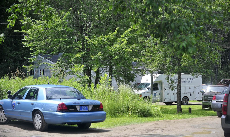 Maine State Police search the residence at 24 Main St in Detroit on Friday where a man was found dead Thursday morning.