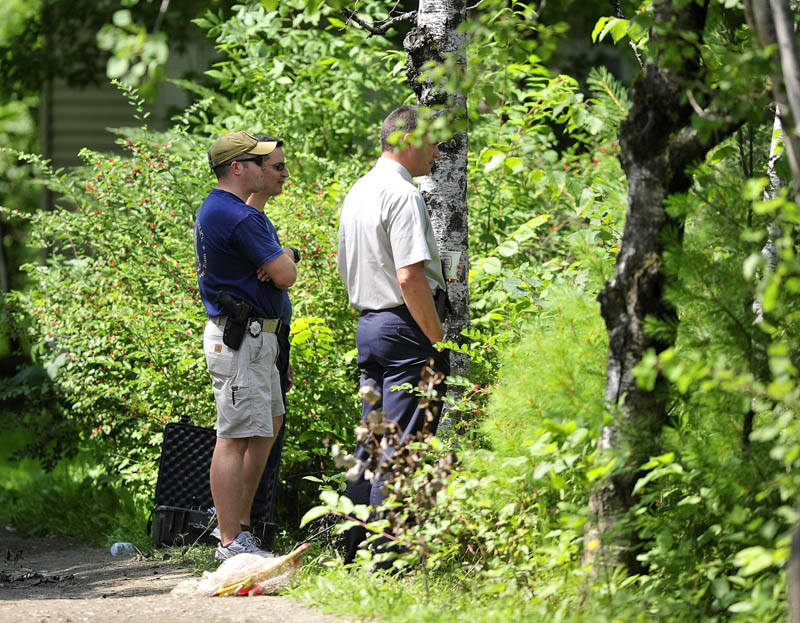 Maine State Police search the residence at 24 Main St in Detroit on Friday where a man was found dead Thursday morning.