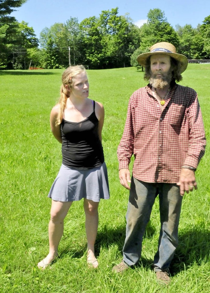 Starks residents Elizabeth Smedberg and Harry Brown speak in a field off Abijay Hill Road on Monday directly below where a proposed 195-foot cell tower will be placed and be visible for miles.