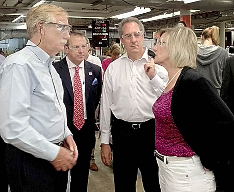U.S. Trade Representative Michael Froman, second from right, listens as New Balance Plant Manager Raye Wentworth, right, leads a tour of the Norridgewock plant today. U.S. Sen. Angus King, left, and New Balance CEO Rob DeMartini listen.