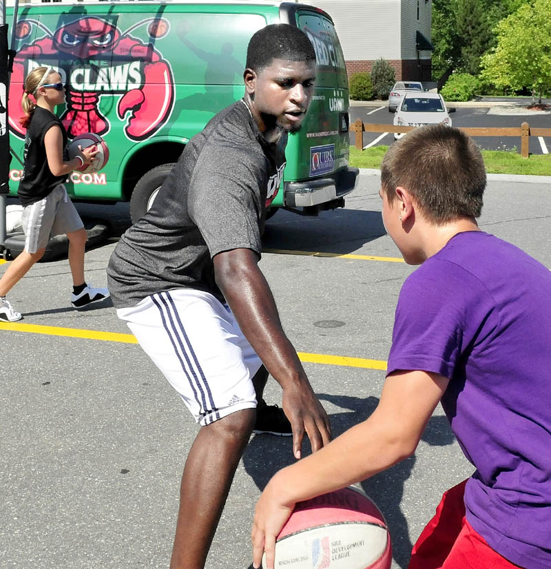 TRAVELING HOOPS: Former Red Claws player Gene Spates and Devin Lebrun play basketball Thursday when the Red Claws stopped in Waterville as part of their Summer Clinic Series.