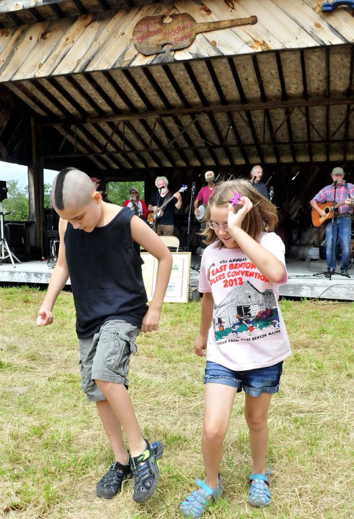 Gerry Moody and his sister, Angel, dance a jig as the Country Choir band performs during the East Benton Fiddler's Contest, Convention and Bluegrass Festival today.