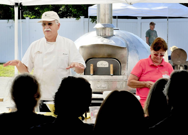 Michael Jubinsky explains the process of making bread in a wood-fired oven during a workshop in the 2013 Kneading Conference in Skowhegan on Thursday. Sandy Jubinsky is at right.