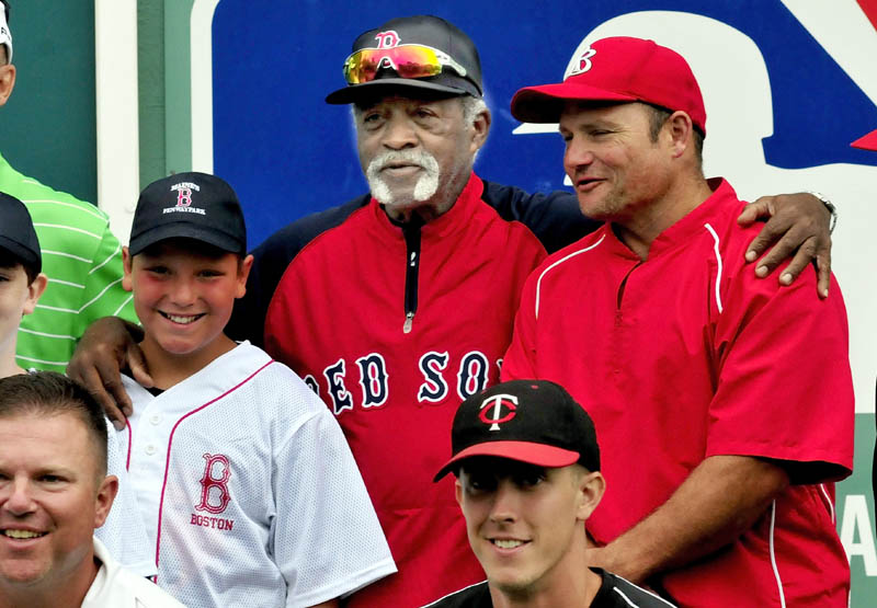 BASEBALL BUDDIES: Former Red Sox pitcher Luis Tiant, center, takes part in a group photograph following a baseball clinic Monday at the Harold Alfond Fenway Park in Oakland.