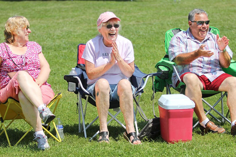 Helen MacDonald, of Norridgewock, center, reacts to a joke by Maine humorist Tim Sample during a comedy set at the 23rd Annual Winslow Family 4th of July Celebration on Wednesday. Sitting next to MacDonald is Janice Murray, of Norridgewock, left, and Wes Danforth, of Winthrop, right. Wednesday was Laughter and Dance at the Park Day.