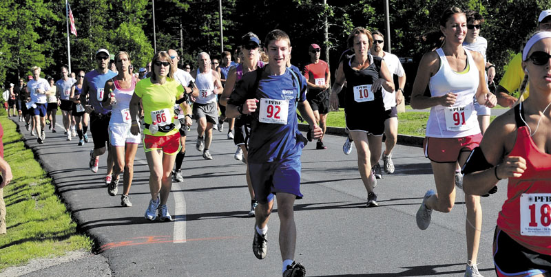 THEY’RE OFF: More than 150 runners take off at the start of the third annual PFBF CPA’s Half Marathon and 5K Run/Walk last year. The fourth edition of the race will be held Sunday, July 14.
