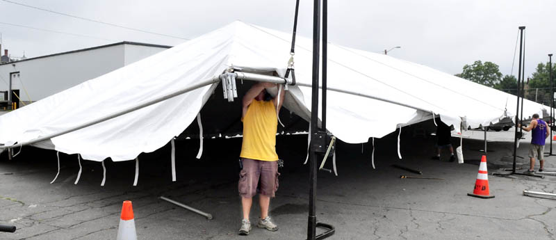 Jeff Humphrey of the Are You Ready To Party company today erects a tent beside the Skowhegan Chamber of Commerce, for the six-day River Fest event that begins Tuesday.