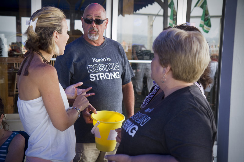 Event organizer Mal Mango of Old Orchard Beach coordinates a 50/50 ticket sale with Heather Dyer and Cheryl Engelhardt during a fundraiser Sunday at The Brunswick to help build a handicapped-accesible home for Boston Marathon bombing victim Karen Rand.