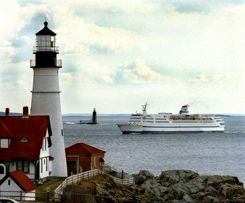 In this April 8, 1997 file photo, the Scotia Prince returns to Portland, Maine for the summer season as it passes the Portland Head light with Ram Island lighthouse in the background. Nova Scotia officials are optimistic that an experienced ferry operator will take their $21 million offer and relaunch a service next summer between Nova Scotia and New England. Portland has been identified as the leading contender to be the U.S. port.