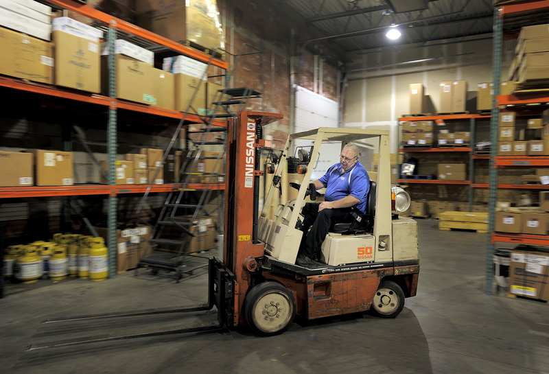 Bob Prescott drives a forklift at his new job for Distributor Corp. of New England in Westbrook last week.