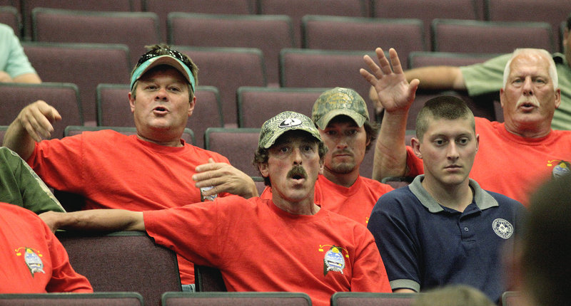 Maine lobstermen react to a point made by Marine Resources Commissioner Patrick Keliher during a meeting Tuesday at Oceanside High School in Rockland.