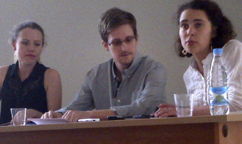 Edward Snowden, center, holds a news conference at Moscow’s Sheremetyevo Airport last Friday with Sarah Harrison, left, of WikiLeaks. Snowden defended his disclosure of secret surveillance undertaken by the United States and said he has no regrets because “it was the right thing to do.” The woman at right was not identified.