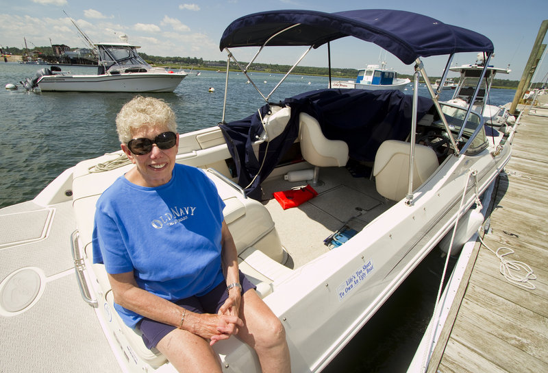 Shirley Polinger of Wells sits on her boat Monday in Wells Harbor, where it was towed after becoming disabled Saturday off the coast. She said when a boater came to her aid, "I was looking at the front of his boat and I saw 'Fidelity IV.' I said, 'Oh my God, it's Bush's boat.'"