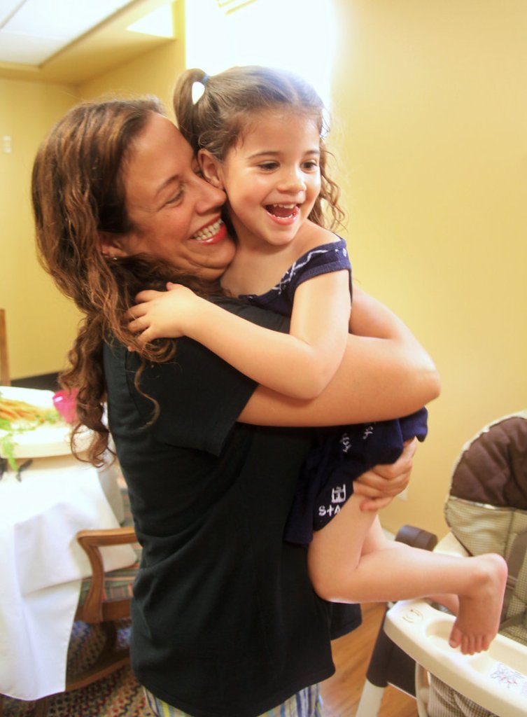 Shelly Fasano shares a hug with her daughter, Gina Carbone, 3, at McAuley Residence in Portland. Fasano is now in the last months of her two-year treatment program.