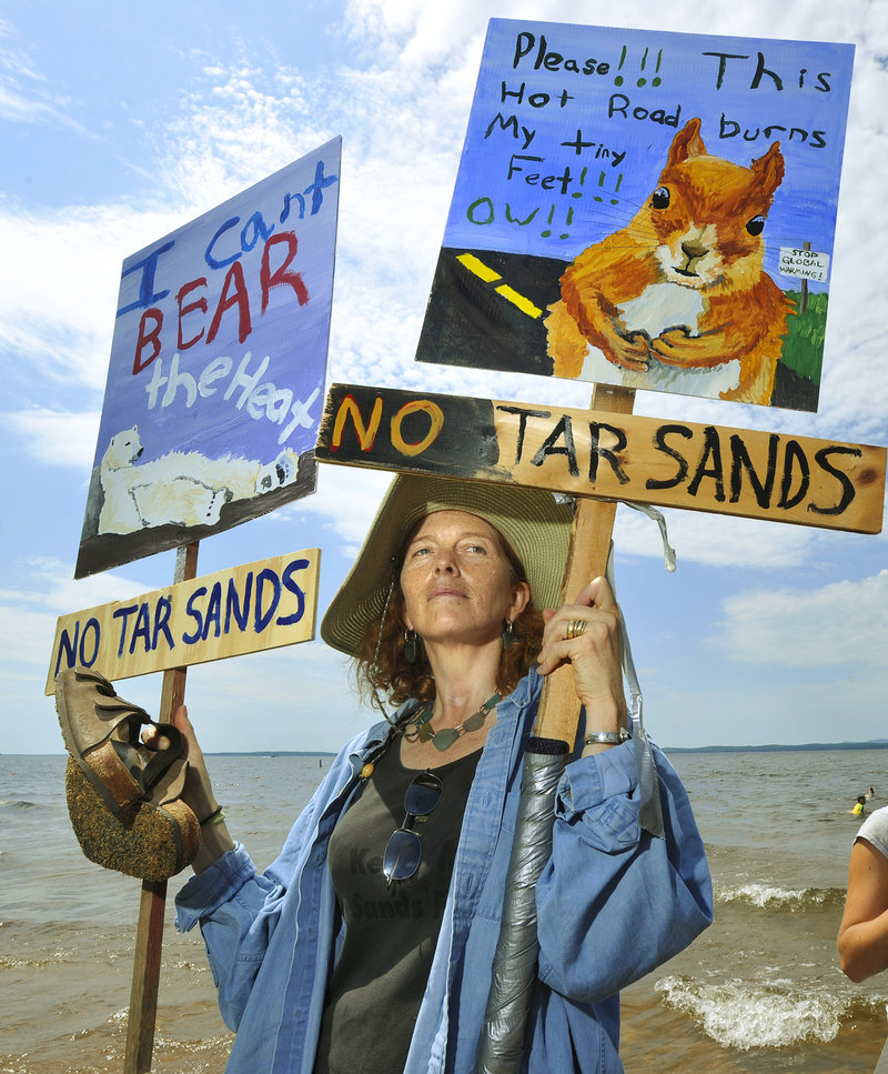 Lynn Stone of Topsham protests at Sebago Lake State Park on Saturday. The pipeline passes within 500 feet of the lake, which supplies Greater Portland’s drinking water.