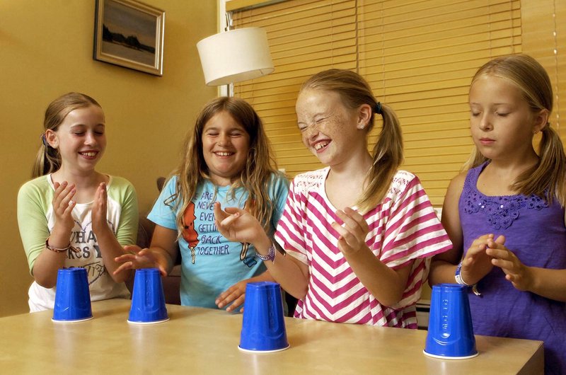 From left to right, Hannah Johnson, Caitlin Guthrie, Katherine Concannon, and Tatum Strunk, all 10 years old and from Cape Elizabeth, share a laugh while practicing the "Cups" song at Johnson's house in Cape Elizabeth, Wednesday, July 24, 2013.