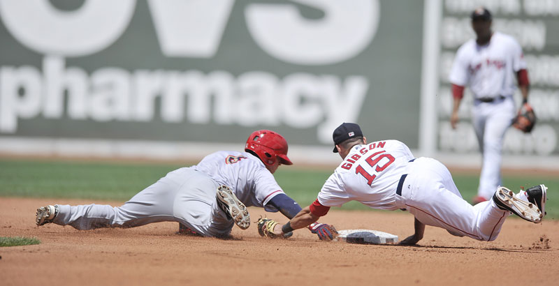 Sea Dog second baseman Derrik Gibson makes a diving attempt to tag Harrisburg's Ricky Hague during the Futures at Fenway game Saturday in Boston. Portland beat Harrisburg 5-2.