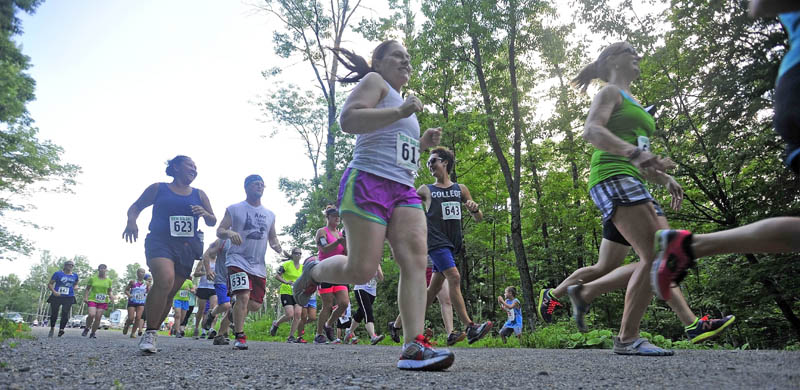 TAKING OFF: Runners leave the starting line for a 5K run at Quarry Road Recreational Area as part of the Quarry Road Summer Race series on Tuesday. The series runs every Tuesday during the summer and race distances vary from week to week.