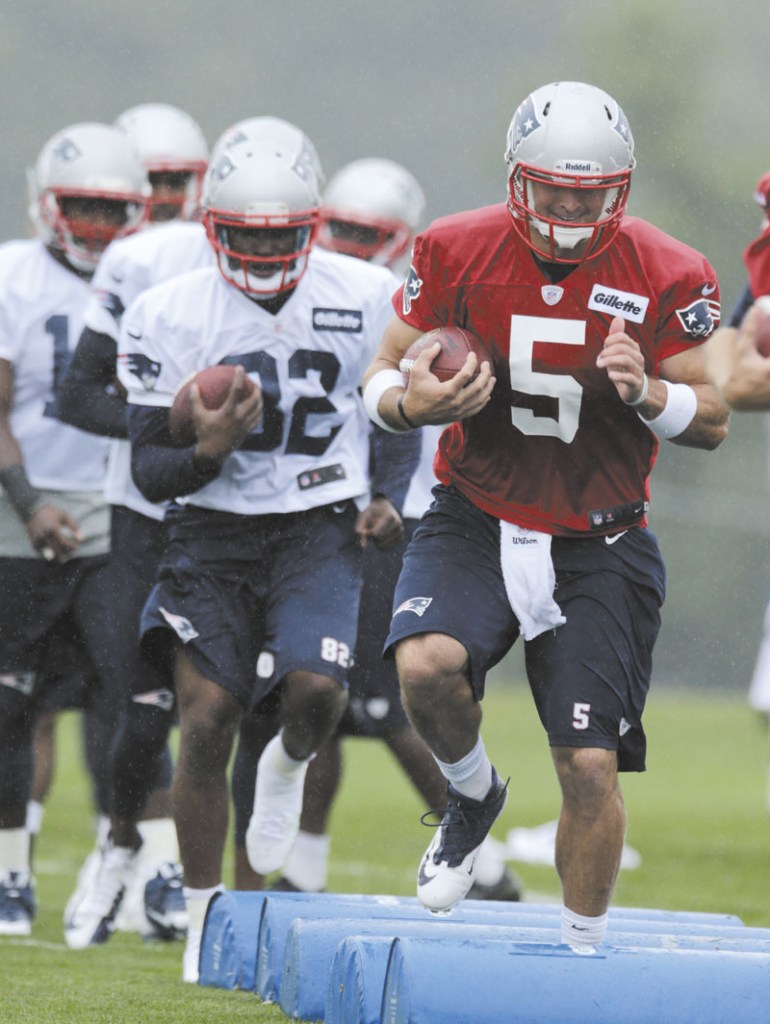 PUTTING IN WORK: New England Patriots quarterback Tim Tebow works out during training camp Friday in Foxborough, Mass. Tebow signed with the Patriots on June 11 to compete for the backup quarterback job.