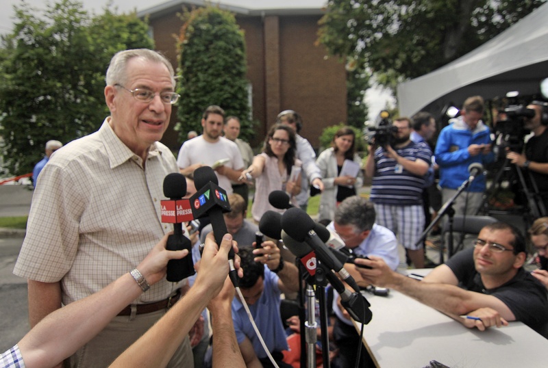 Ed Burkhardt, chairman of Montreal, Maine & Atlantic Railway, speaks to the media in Lac-Megantic, Quebec, in July. The top U.S. railroad administrator has written to him seeking assurance that the railroad won't use one-person crews in the U.S. :rel:d:bm:GF2E97A1KGQ01