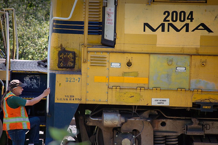In this July 31,2 013 file photo, a crew from Montreal, Maine & Atlantic Railway works to put a derailed locomotive back on the tracks in Brownville. Canadian conglomerate J.D. Irving Ltd.'s NB&M Railways has been in discussions with the state about the process of buying the embattled MM&A Railway.