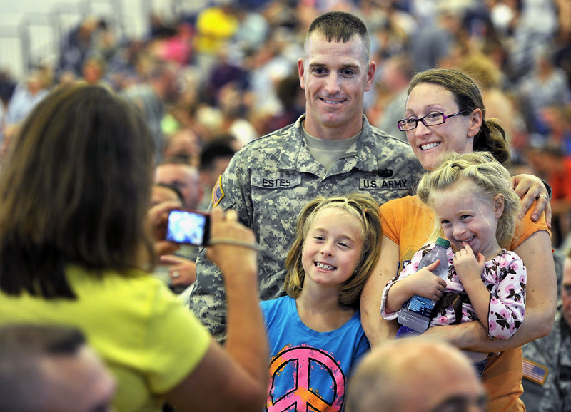Staff Sgt. Ryan Estes and his family pose for a photo before the start of Saturday's "Hero's Send-Off Ceremony" at the Portland Expo. He is a member of the a Maine Army National Guard unit that is deploying to Afghanistan. With him are his wife, Myra; and daughters Peyton, 8, left, and Dakota, 3.